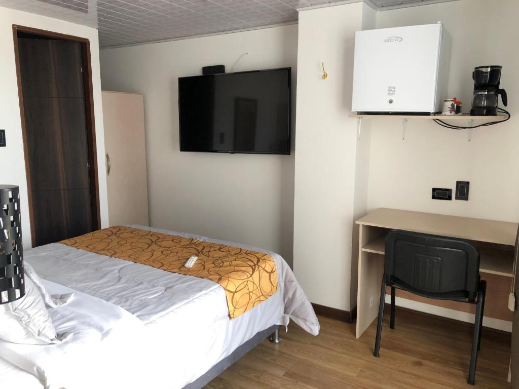 Postel nebo postele na pokoji v ubytování Hotel Casa Modelia