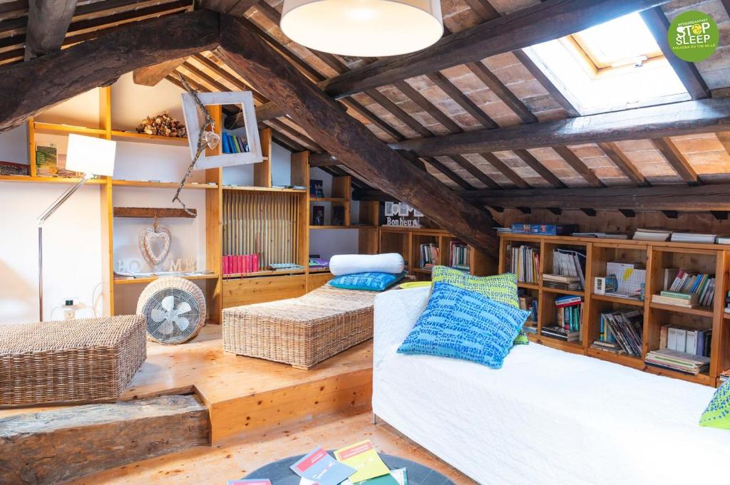 a living room with a white couch and wooden ceilings at Stop & Sleep Fagagna on the Hills in Fagagna