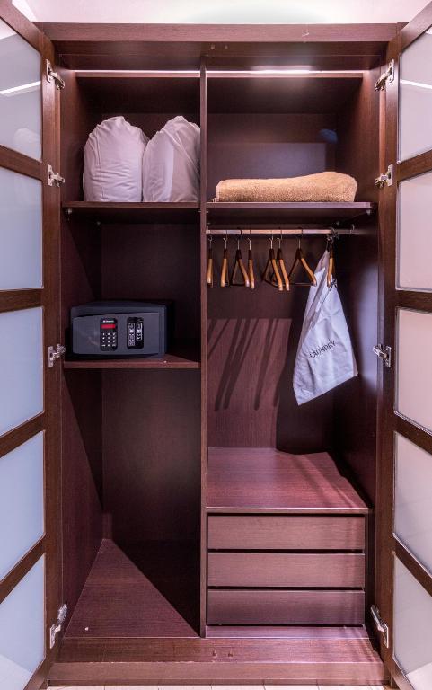 a walk in closet with wooden shelves and a drawer at Hotel Madanis in Barcelona
