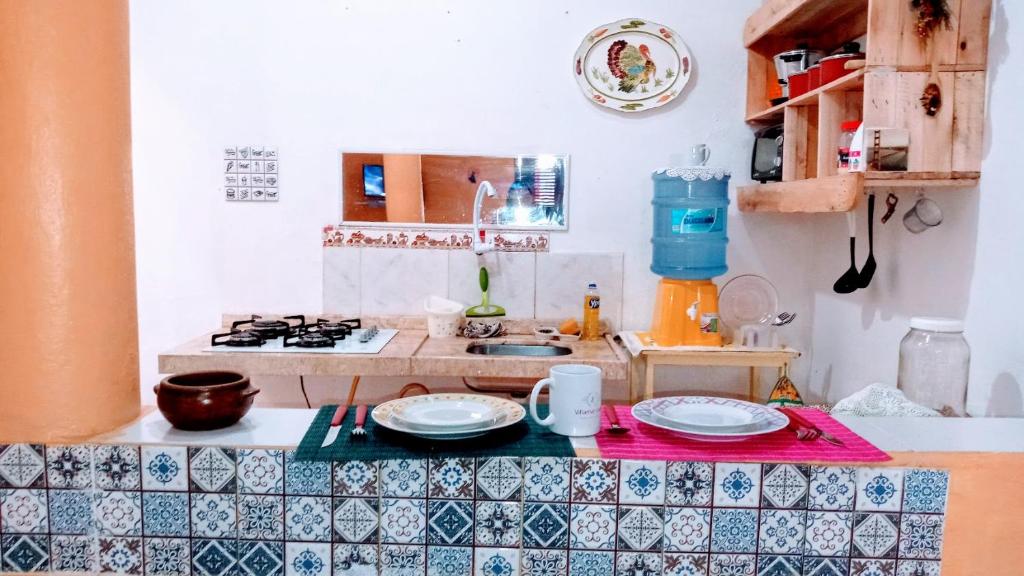 a kitchen with a counter with plates on it at Villamar temporada -praia do futuro in Fortaleza