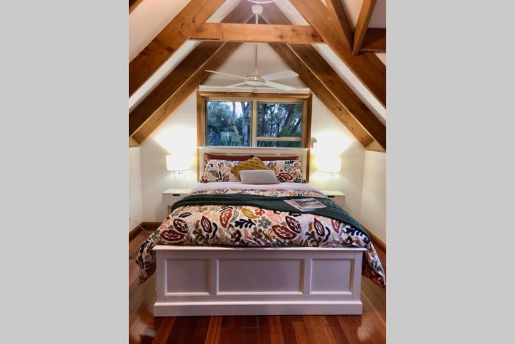 a bedroom with a bed in a attic at Lower Mountains Retreat in Warrimoo