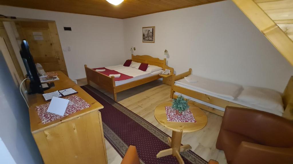 A bed or beds in a room at Hotel Koliba