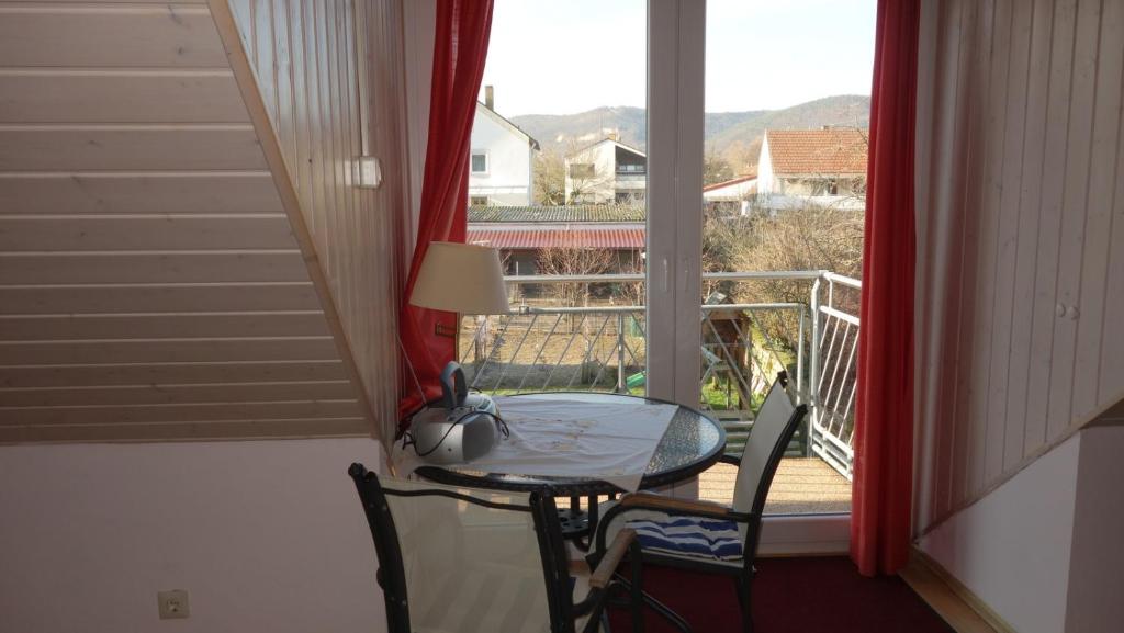 a balcony with a table and chairs and a window at Ferienhaus - Kern in Böchingen