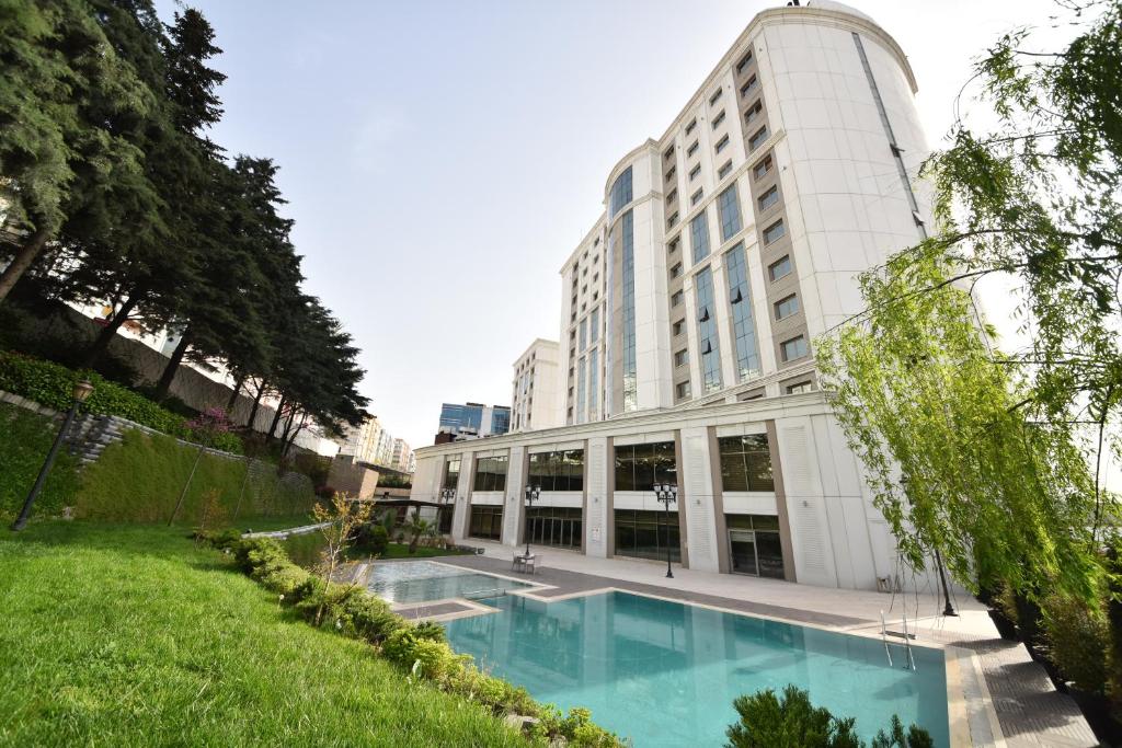 a large building with a fountain in the middle of it at Istanbul Gonen Hotel in Istanbul