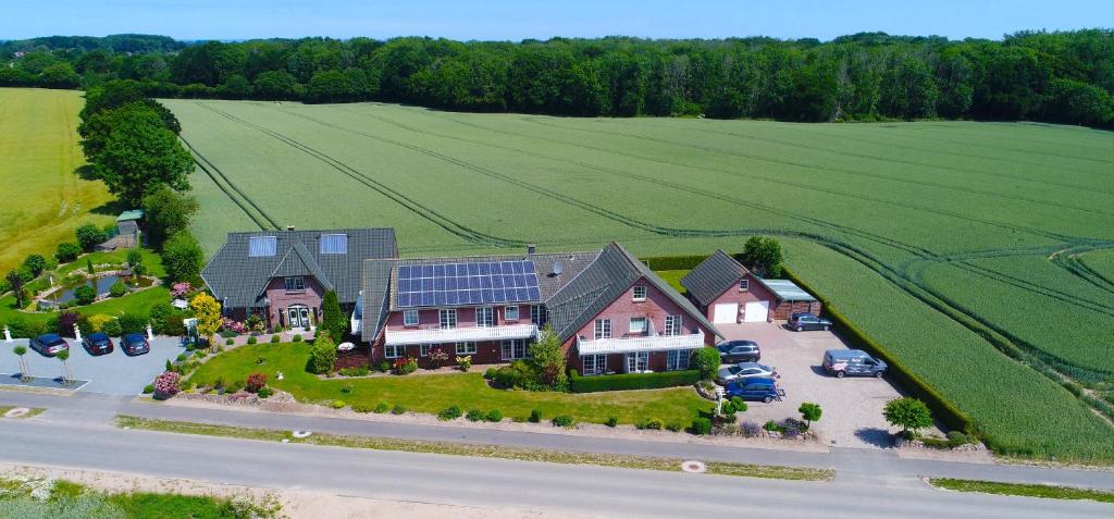 an aerial view of a house with solar panels on it at Hasselberger Huus in Hasselberg