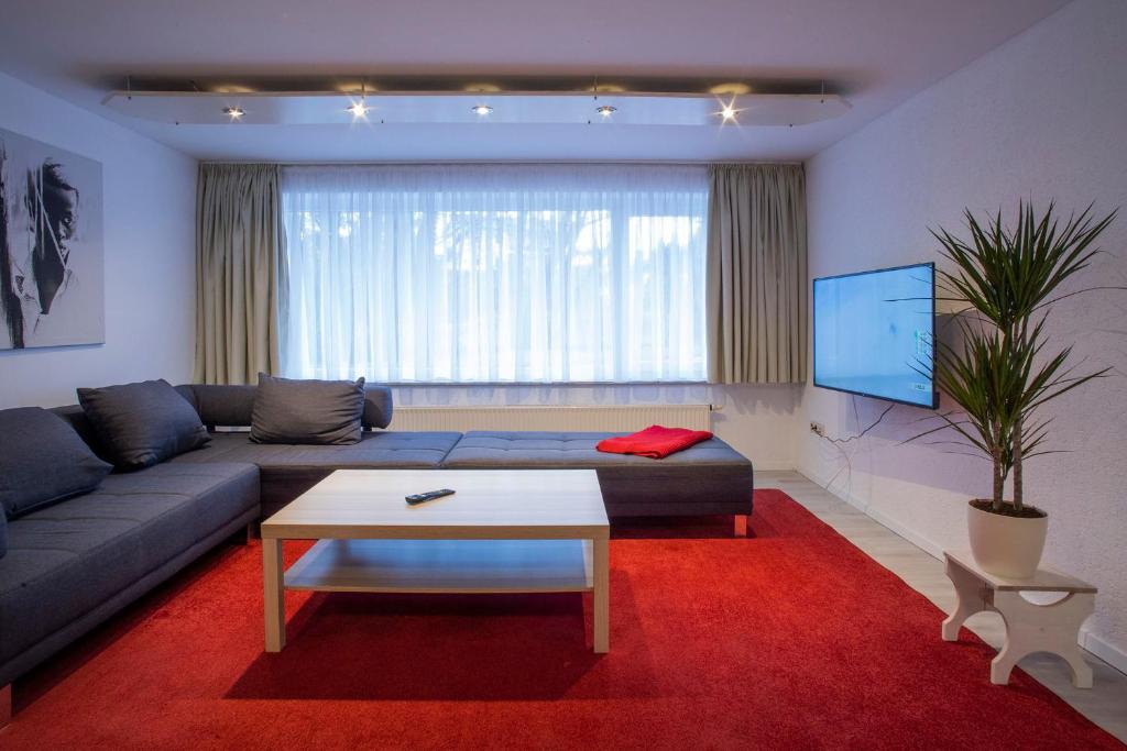 a living room with a couch and a tv at Im Reuter FEWO2 in Sinsheim