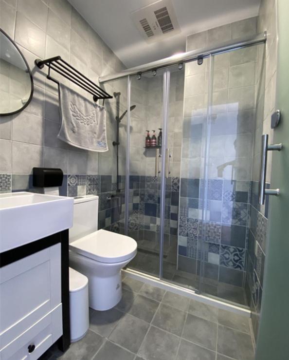 a bathroom with a shower and a toilet and a sink at 東莒 找茶複合式民宿-連江縣民宿199號 in Juguang