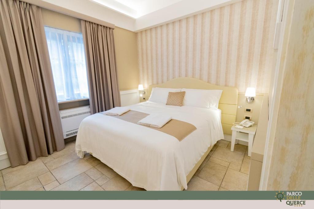 Postel nebo postele na pokoji v ubytování Hotel Parco delle Querce