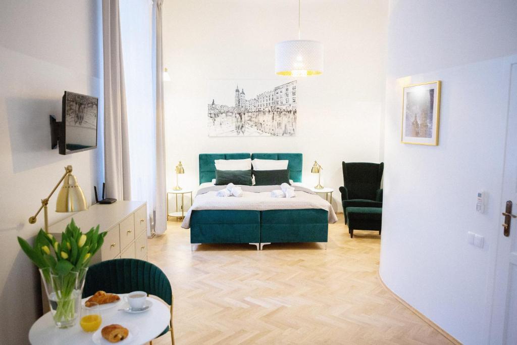a bedroom with a bed and a table and chairs at Apartments Roman in Kraków