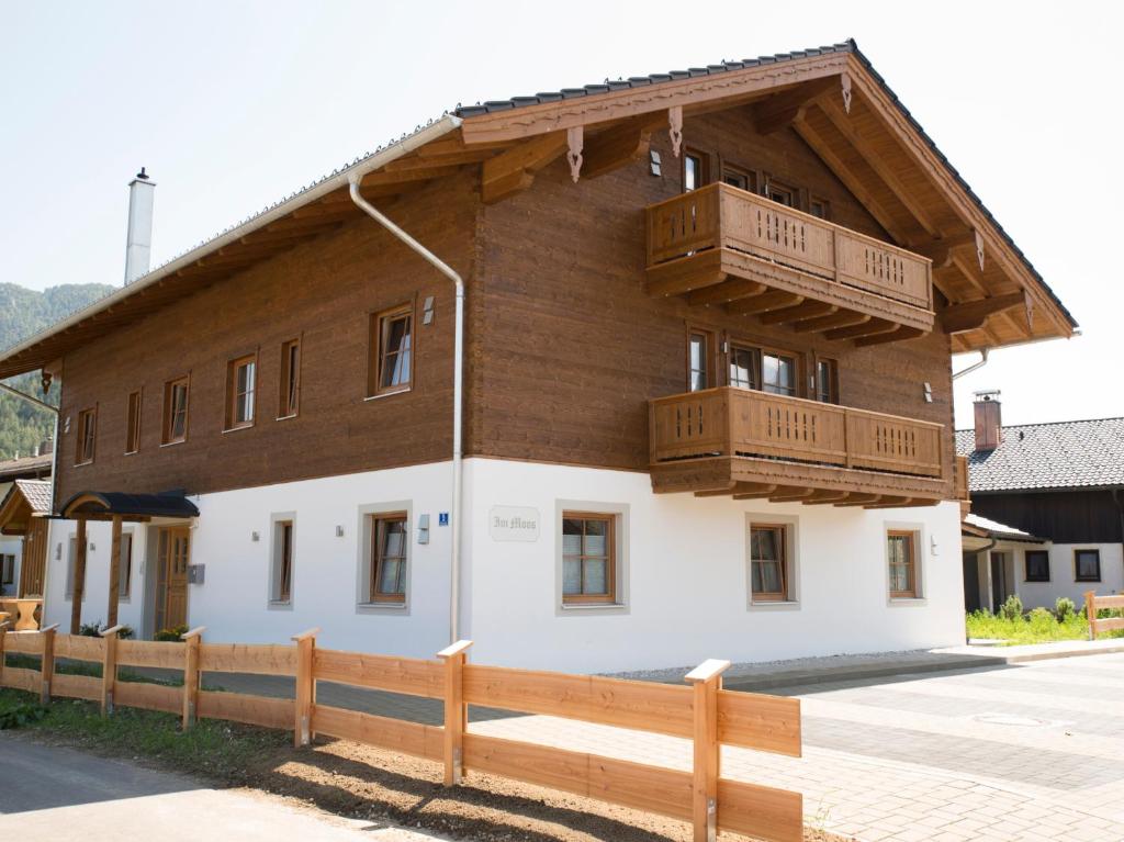 a large building with wooden balconies on top of it at Haus im Moos - Chiemgau Karte in Inzell