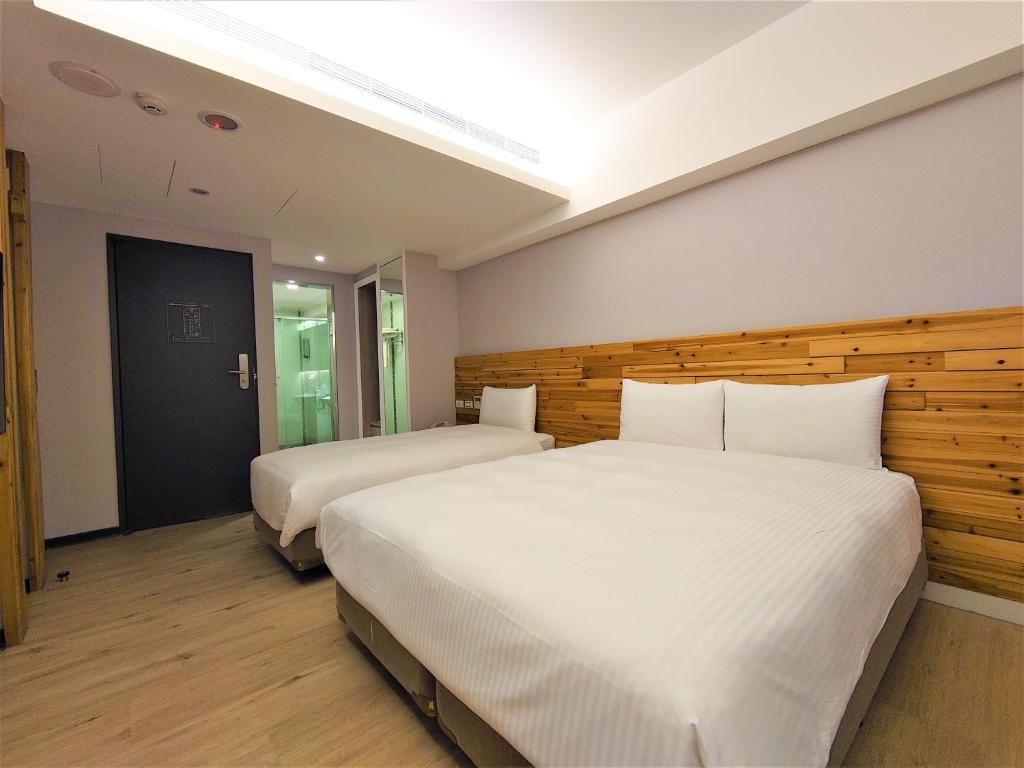 Postel nebo postele na pokoji v ubytování Hub Hotel Ximen Inn