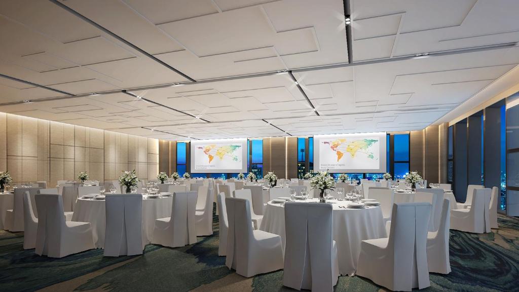 a conference room with white tables and chairs and screens at Holiday Inn Chengde Park View, an IHG Hotel in Chengde