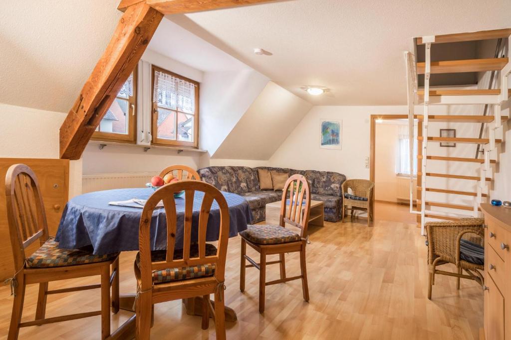 a living room with a table and chairs and a couch at Ferienwohnung Nr 2 in Deggenhausertal