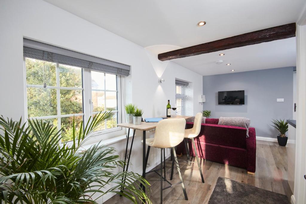 a living room with a table and a couch at Gateway Mews - Serviced Apartments in Kegworth