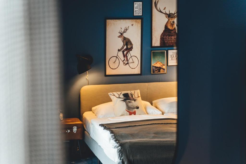 a bedroom with a bed with a dog on a bike at Hotel Sportalm in Bad Kleinkirchheim