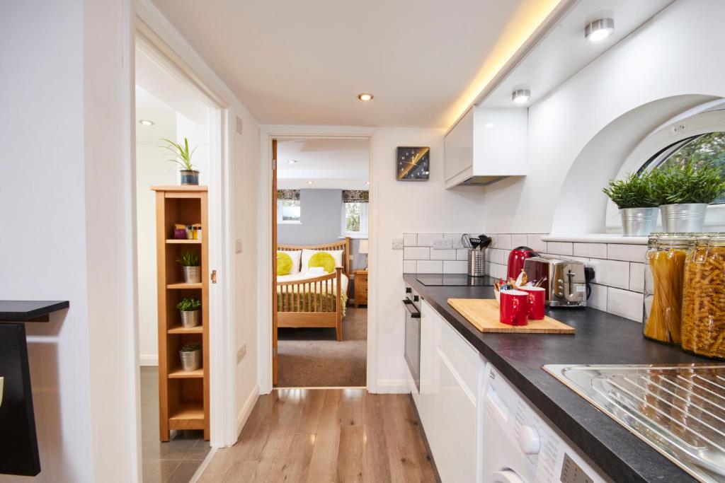 a kitchen with white cabinets and a counter top at The Hidden Gem in Kegworth