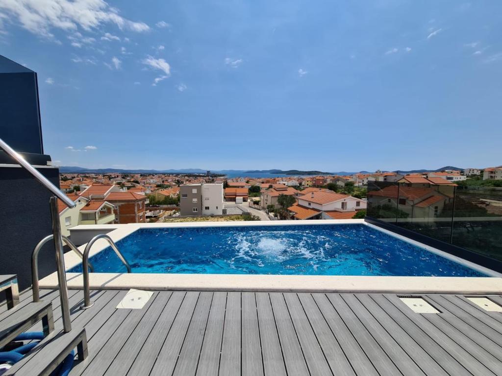 a swimming pool on a deck with a view of a city at Villa Lio I in Vodice