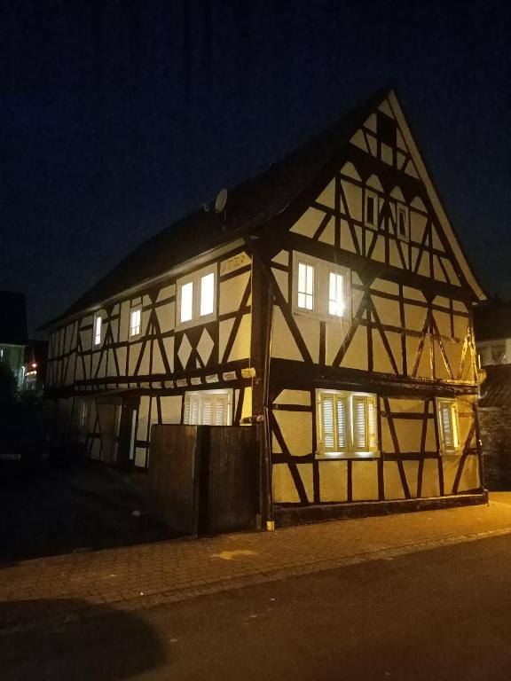 abered building with lights on in the night at historisches Fachwerkhaus in Alzenau