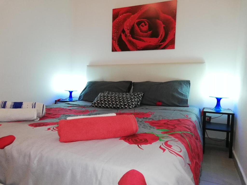 a bedroom with a bed with a red blanket at Home&Sharm Reitani in Catania