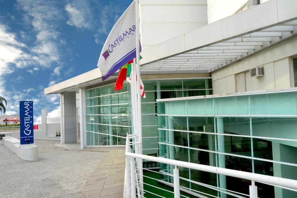 a building with a flag in front of it at Castelmar Hotel in Florianópolis