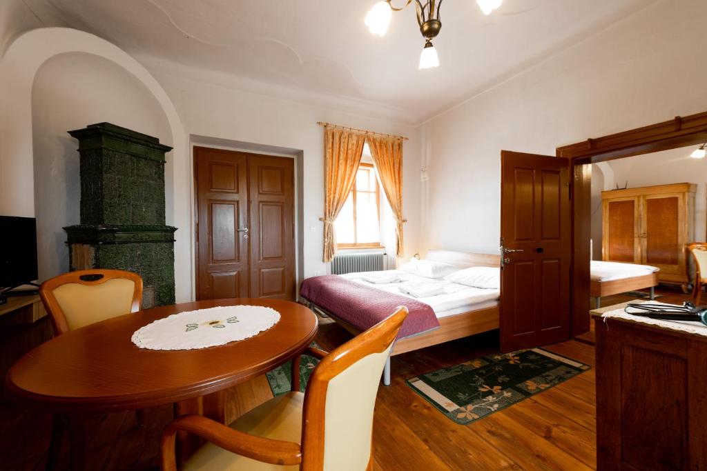 a bedroom with a bed and a table and a table and chairs at Sobodajalstvo Obal in Cankova