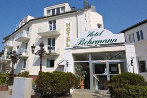 a large white building with a sign on it at Hotel Behrmann in Hamburg
