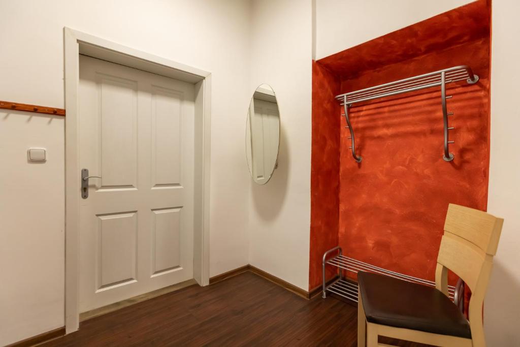 a room with a white door and a mirror at Palác Daun - Studio Apartments in Znojmo