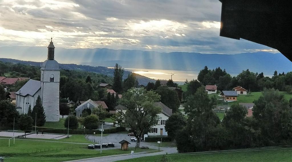 a view of a small town with a church at Balcony of lake Geneva in Thollon