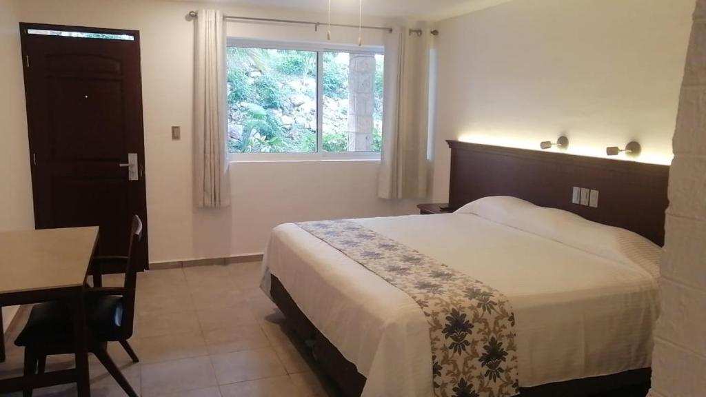 Postel nebo postele na pokoji v ubytování Hotel Puerta Chichen