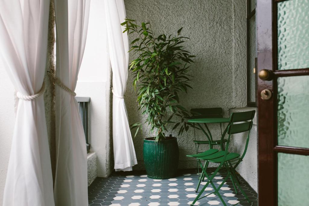 a room with a table and a potted plant at The Convent Hotel in Auckland