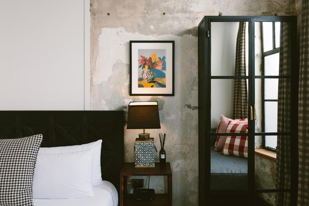 a bedroom with a bed and a mirror at The Convent Hotel in Auckland