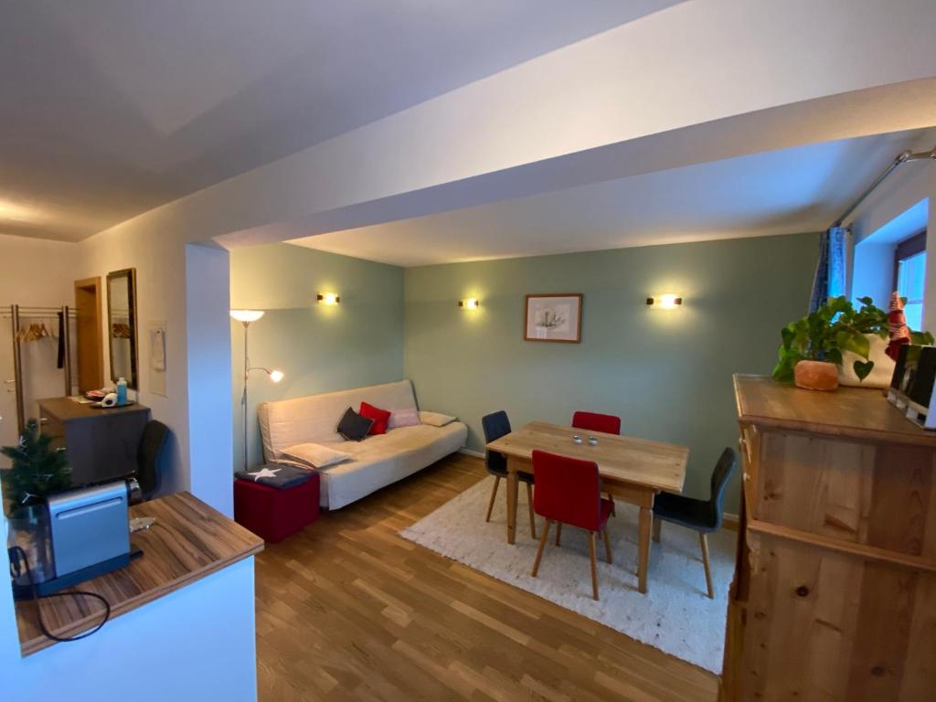 a living room with a table and a couch at Genner in Kitzbühel
