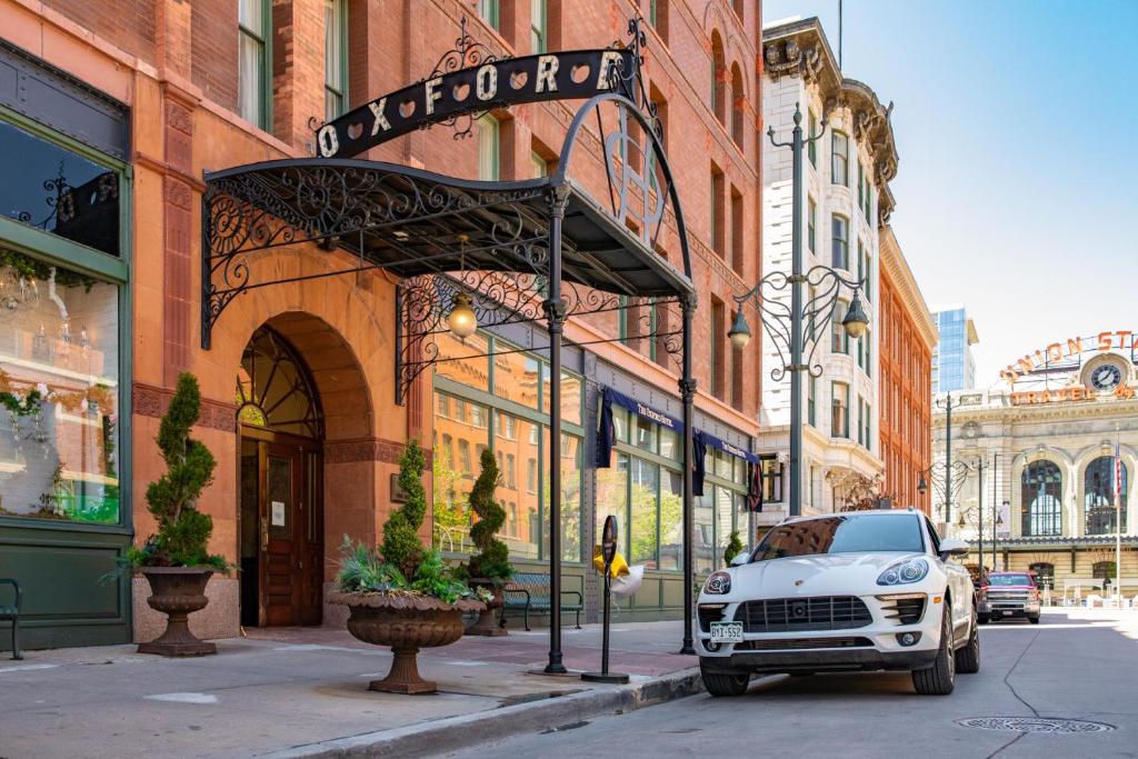 a white truck parked in front of a building at The Oxford Hotel in Denver