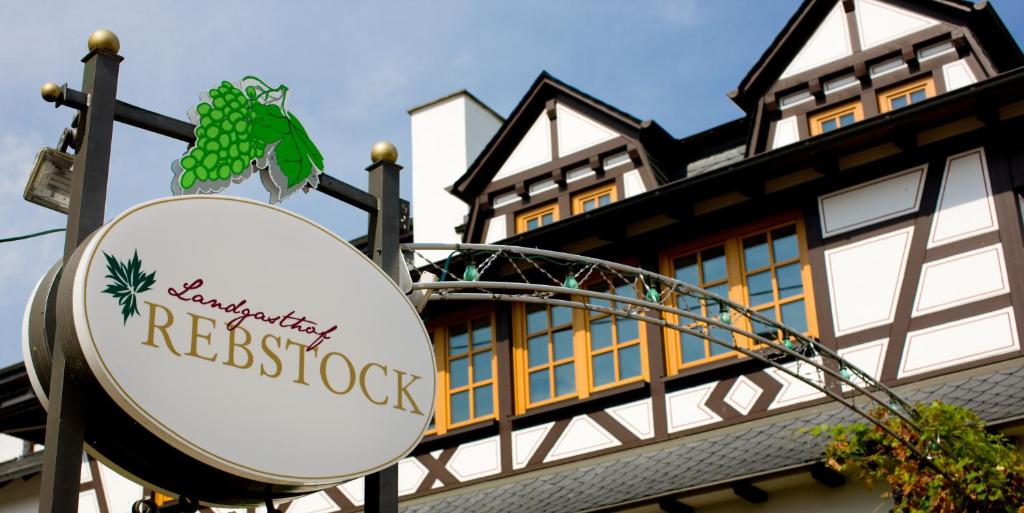 a sign for a restaurant in front of a building at Landgasthof Rebstock in Sankt Goar