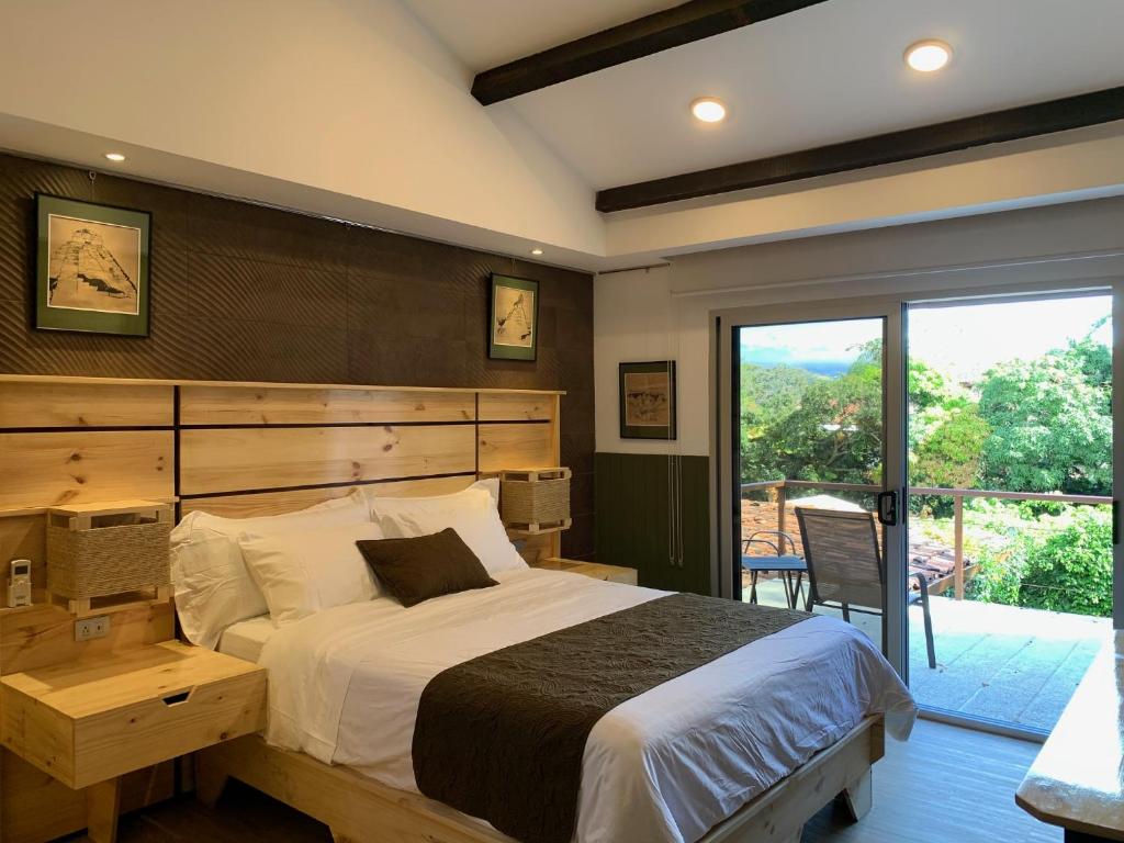 a bedroom with a large bed and a balcony at ARANJUEZ LOFTS Santa Ana in Santa Ana