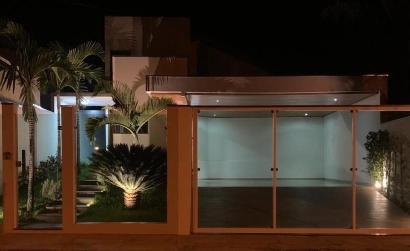 a building with a glass door with a palm tree at Casa Recanto da Paz in São João Batista do Glória