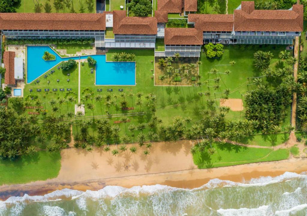 an aerial view of a resort with a beach at The Blue Water in Wadduwa