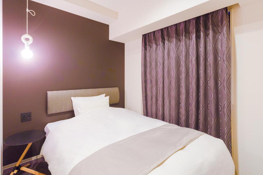 Postel nebo postele na pokoji v ubytování Hotel M's Est Shijo Karasuma