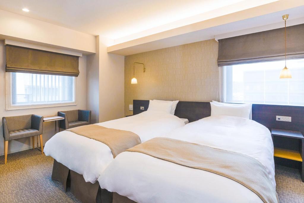 Postel nebo postele na pokoji v ubytování Hotel M's Est Shijo Karasuma
