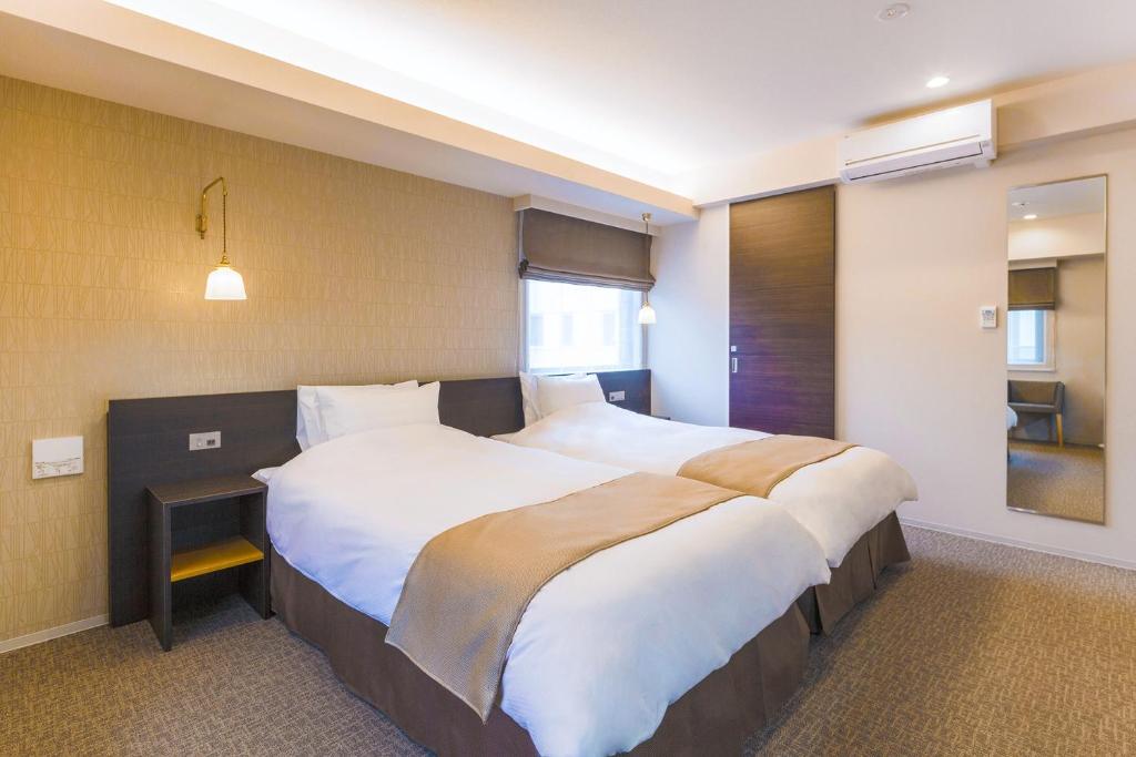 Postel nebo postele na pokoji v ubytování Hotel M's Est Shijo Karasuma