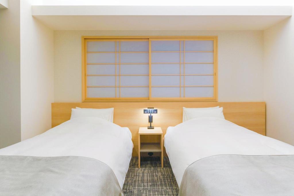 Postel nebo postele na pokoji v ubytování Hotel M's Est Shijo Karasuma