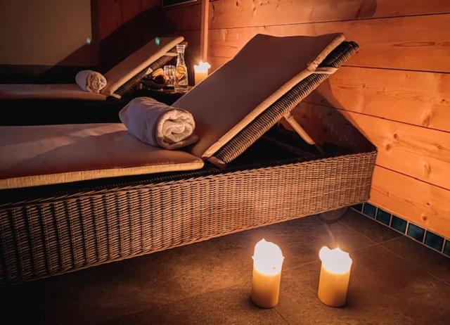 a room with two candles and a bed with towels at Hotel Steinbock in Klosters