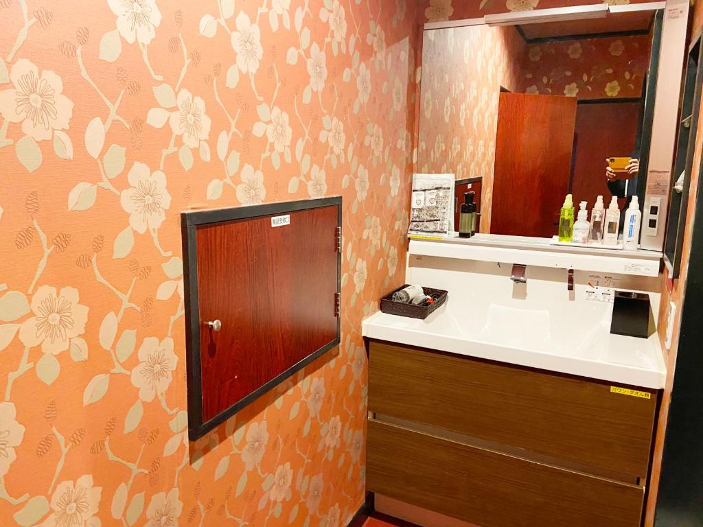 a bathroom with a sink and a mirror at Wink in Saijo