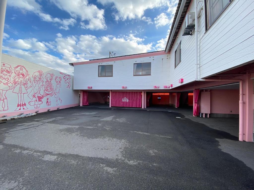 an empty parking lot in front of a building at Wink in Saijo