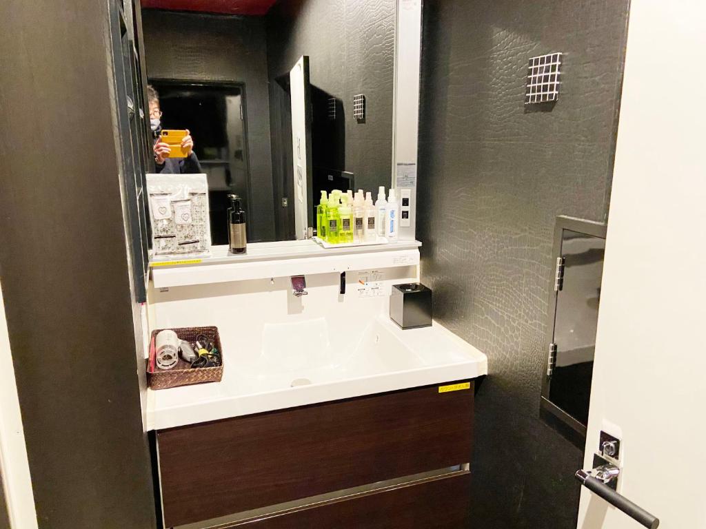 a bathroom with a sink and a mirror at Wink in Saijo