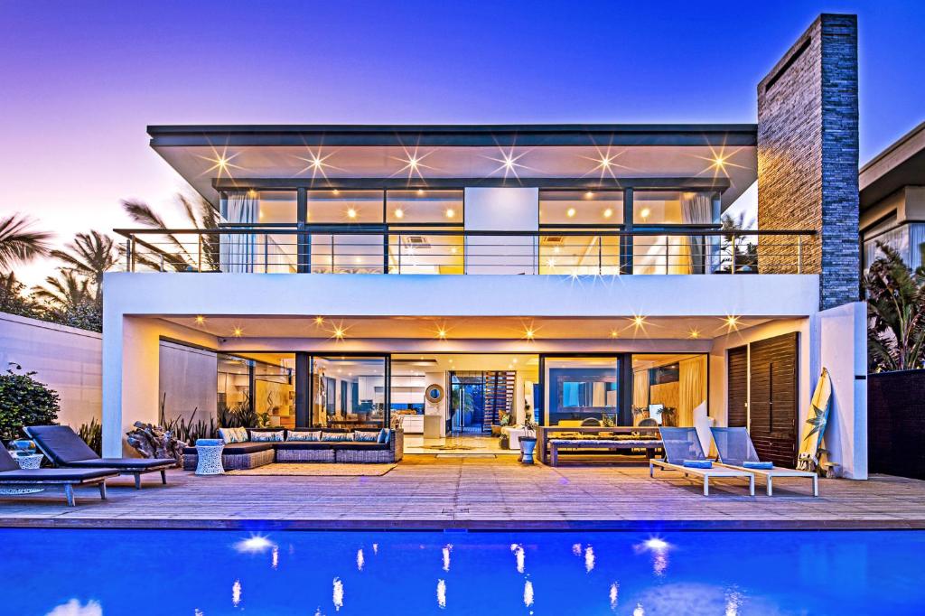 a house with a pool in front of it at Dolphin Coast YOLO Spaces - Beach House Villa in Ballito