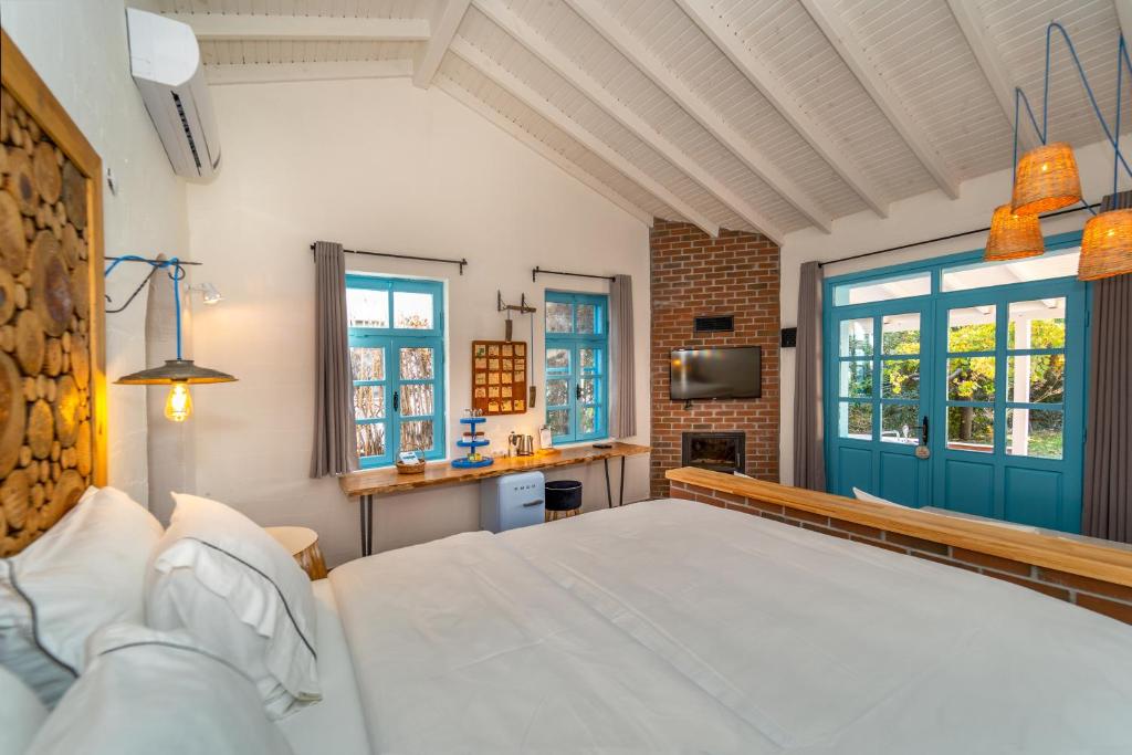 a bedroom with a bed and a blue door at Yonca Lodge in Fethiye