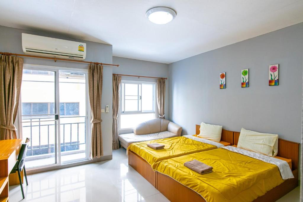 巴吞他尼的住宿－Fenix，一间卧室配有一张黄色毯子床
