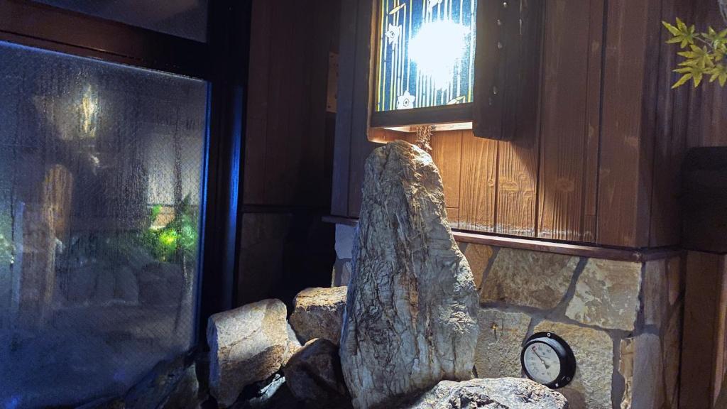 a stone wall with a window with a large rockigunigun at Dormy Inn Akihabara in Tokyo
