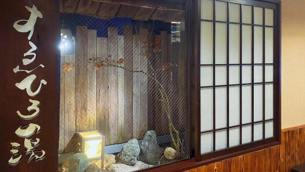 an entrance to a room with a fish tank at Dormy Inn Akihabara in Tokyo